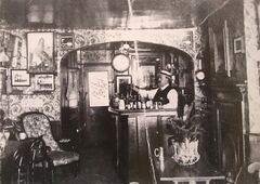 Interior of Oddfellows Arms with landlord Charles Rogers at the bar c1905